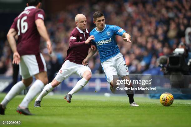 Steven Naismith of Heart of Midlothian vies with Declan John of Rangers during the Ladbrokes Scottish Premiership match between Rangers and Hearts at...