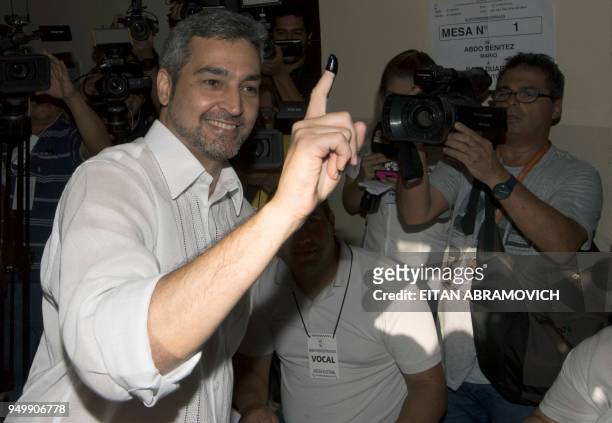 Paraguay's presidential candidate of the ruling conservative Colorado Party, Mario Abdo Benitez shows his inked finger after voting at a polling...