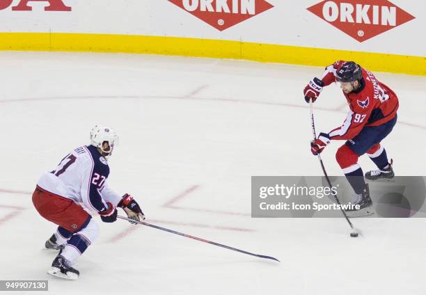 Washington Capitals center Evgeny Kuznetsov winds up to shoot past Columbus Blue Jackets defenseman Ryan Murray during the first round Stanley Cup...