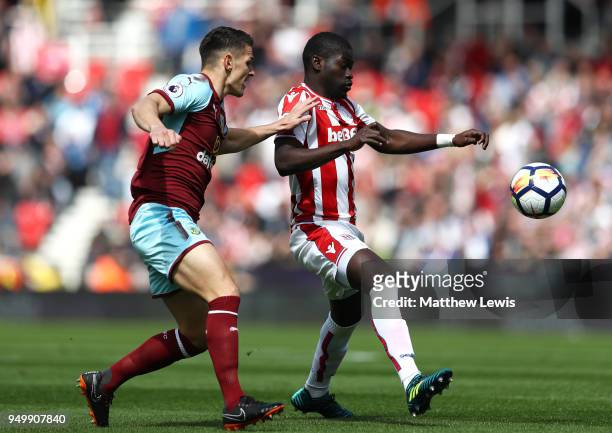 Ashley Westwood of Burnley and Badou Ndiaye of Stoke City battle for the ball during the Premier League match between Stoke City and Burnley at...