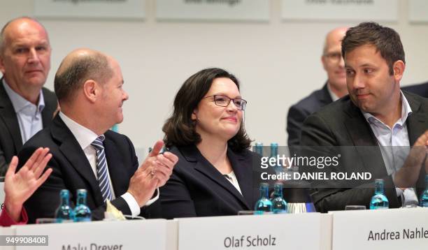 Parliamentary group leader of the Social Democratic Party Andrea Nahles is applauded by German Finance Minister and Vice-Chancellor Olaf Scholz and...