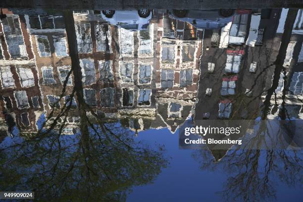 The Reguliersgracht canal reflects houses and blue sky in Amsterdam, Netherlands, on Friday, April. 20, 2018. Brexit will lead as many as 30...