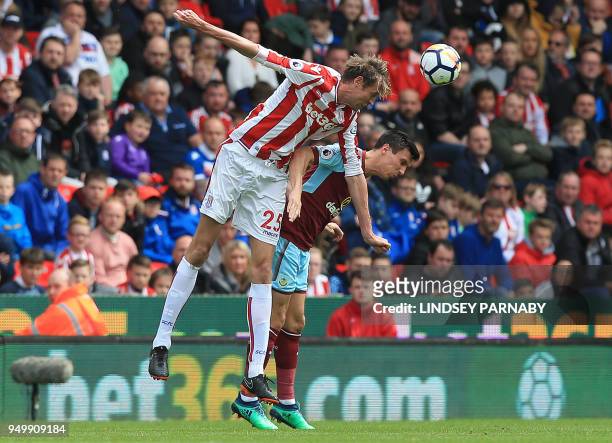 Stoke City's English striker Peter Crouch vies to head the ball with Burnley's English midfielder Jack Cork during the English Premier League...