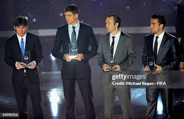 Lionel Messi, Steven Gerrard, Andres Iniesta and Xavi line up after receiving their FIFA/FIFPro World XI awards during the FIFA World Player Gala on...