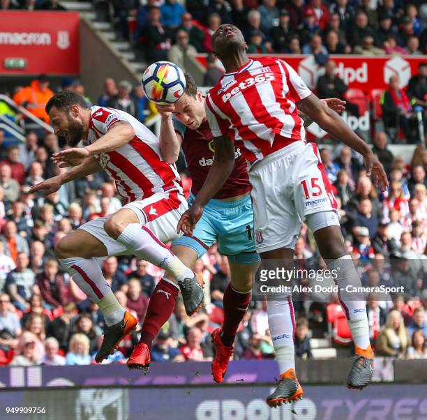 Burnley's Ashley Barnes jumps for a header with Stoke City's Bruno Martins Indi and Erik Pieters during the Premier League match between Stoke City...