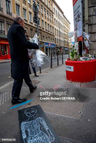 Gérard Collomb dépose un bouquet de roses à l'endroit de l'accident en hommage à Anne-Laure victime d'un chauffard, le 3 décembre 2016 à Lyon, France.