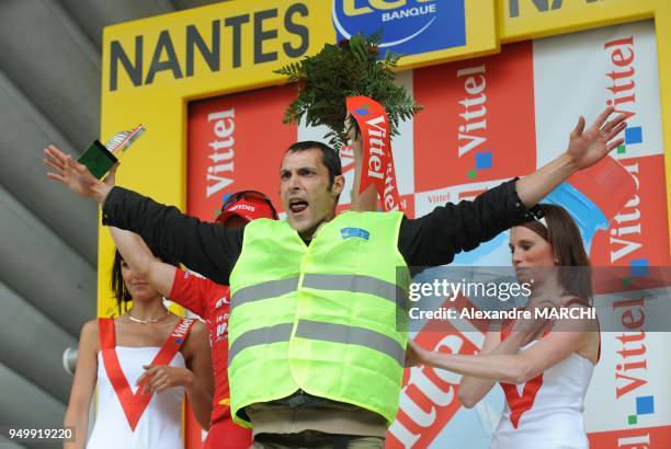 One anti-airport protestor in the podium, on July 7 2008 in Nantes, at the end of the 208 km third stage of the 2008 Tour de France cycling race run...