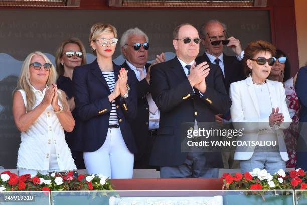 Prince's Albert II of Monaco flanked by his wife Princess Charlene and his cousin Elisabeth-Anne de Massy as they attend the final match in the...