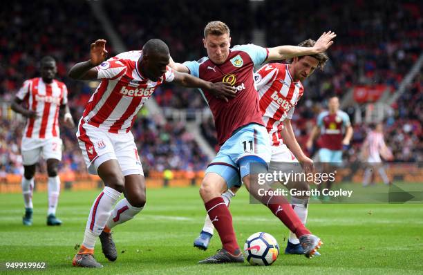 Bruno Martins Indi, Joe Allen of Stoke City and Chris Wood of Burnley in action during the Premier League match between Stoke City and Burnley at...