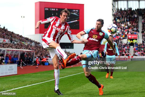 Peter Crouch of Stoke City in action with Stephen Ward of Burnley during the Premier League match between Stoke City and Burnley at Bet365 Stadium on...