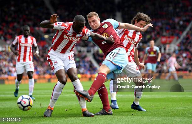 Bruno Martins Indi, Joe Allen of Stoke City and Chris Wood of Burnley in action during the Premier League match between Stoke City and Burnley at...