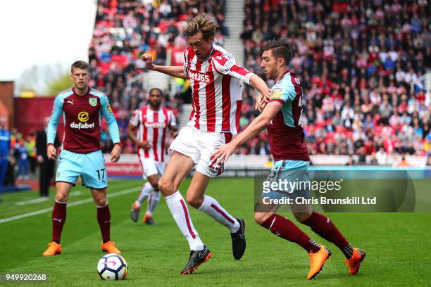 Peter Crouch of Stoke City in action with Stephen Ward of Burnley during the Premier League match between Stoke City and Burnley at Bet365 Stadium on...