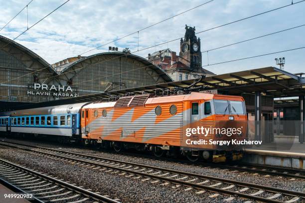 electric locomotive with passenger train at prague main station - prague train stock pictures, royalty-free photos & images