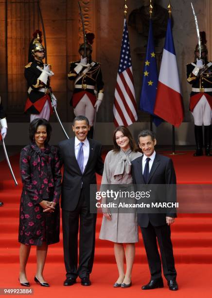 President Barack Obama with US first lady Michelle Obama, France's President Nicolas Sarkozy and France's first lady Carla Bruni-Sarkozy pose during...