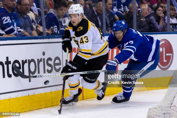 Nikita Zaitsev of the Toronto Maple Leafs chases Danton Heinen of the Boston Bruins in Game Four of the Eastern Conference First Round during the...