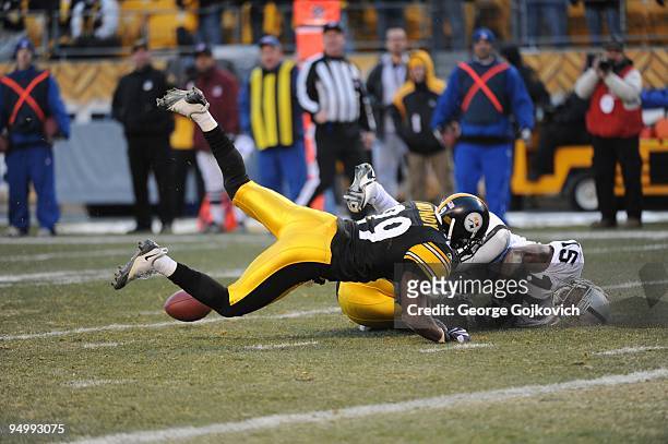 Defensive backs Ryan Mundy and Ryan Clark of the Pittsburgh Steelers break up a pass intended for wide receiver Johnnie Lee Higgins of the Oakland...