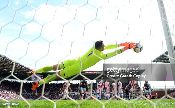Jack Butland of Stoke City saves a free kick from Johann Gudmundsson of Burnley during the Premier League match between Stoke City and Burnley at...