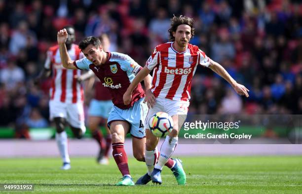 Jack Cork of Burnley and Joe Allen of Stoke City in action during the Premier League match between Stoke City and Burnley at Bet365 Stadium on April...