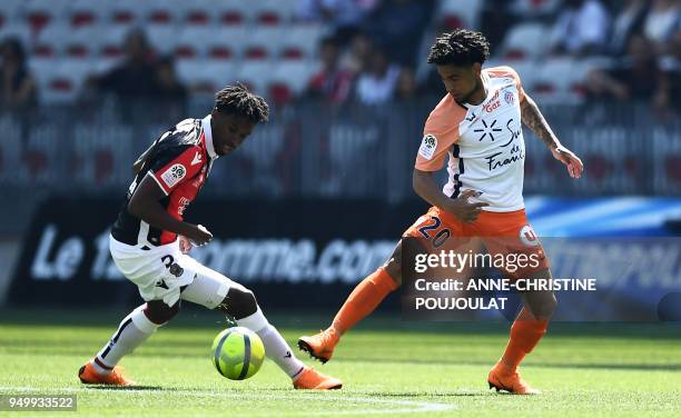 Nice's French midfielder Adrien Tameze vies with Montpellier's South African midfielder Keagan Dolly on April 22, 2018 at the Allianz Riviera Stadium...