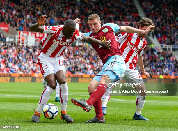 Burnley's Chris Wood battles with Stoke City's Bruno Martins Indi and Joe Allen during the Premier League match between Stoke City and Burnley at...