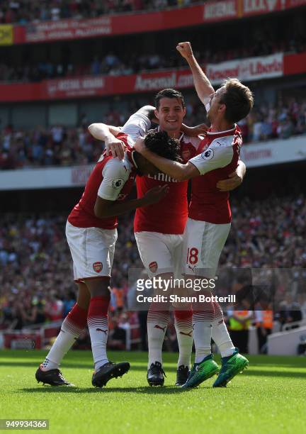 Nacho Monreal of Arsenal celebrates scoring his side's first goal with Granit Xhaka and Alex Iwobi during the Premier League match between Arsenal...