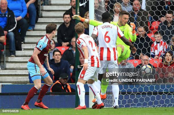 Burnley's English striker Ashley Barnes watches his shot pass Stoke City's English goalkeeper Jack Butland as he scores his team's first goal during...