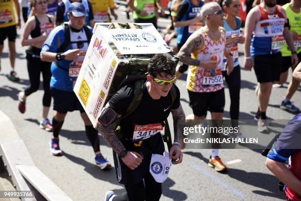 Costumed runner attempting a Guinness World Record participates in the 2018 London Marathon in central London on April 22, 2018. - Guinness World...