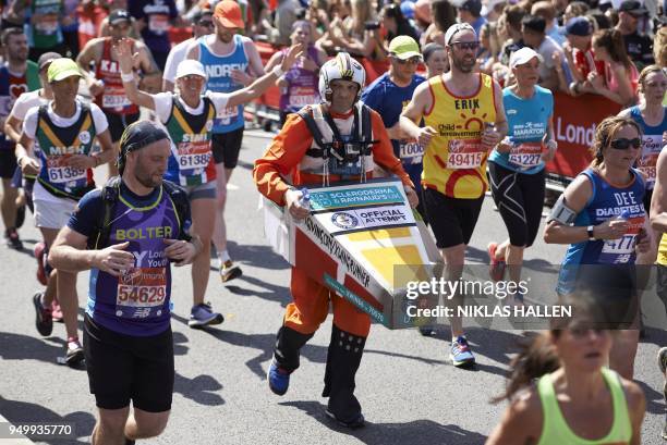 Costumed runner attempting a Guinness World Record participates in the 2018 London Marathon in central London on April 22, 2018. - Guinness World...