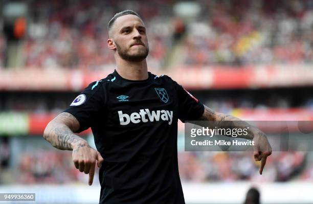 Marko Arnautovic of West Ham United celebrates scoring his side's first goal during the Premier League match between Arsenal and West Ham United at...