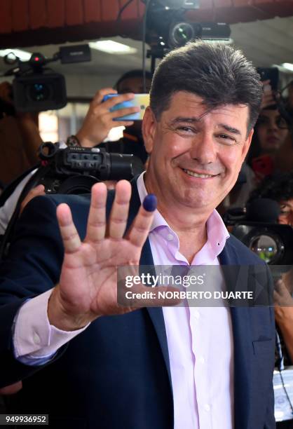 Paraguay's presidential candidate for the National Alliance party, Efrain Alegre, shows his inked finger after voting at a polling station in...