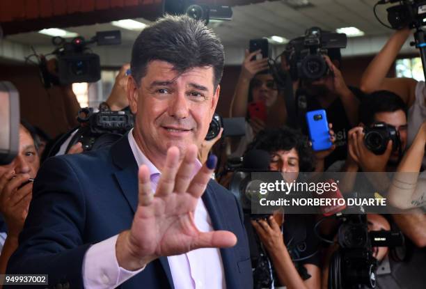 Paraguay's presidential candidate for the National Alliance party, Efrain Alegre, shows his inked finger after voting at a polling station in...