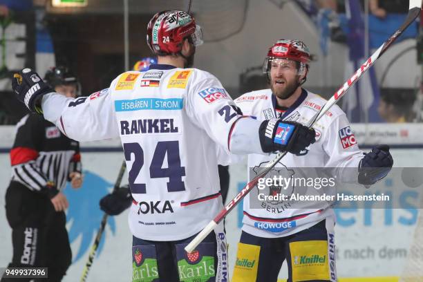 Andre Rankel of Eisbaeren Berlin celebrates scoring the 4th goal with his team mate Mark Olver during the DEL Playoff final match 5 between EHC Red...