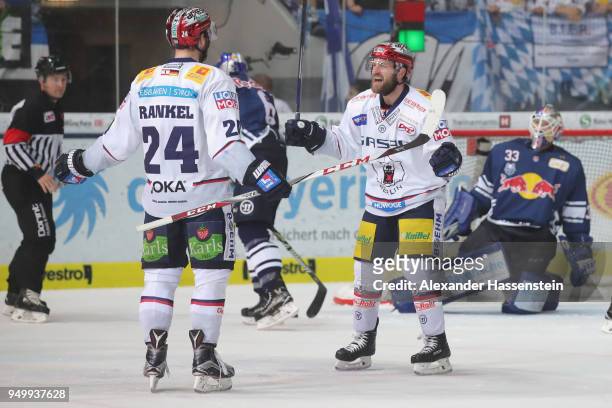 Andre Rankel of Eisbaeren Berlin celebrates scoring the 4th goal with his team mate Mark Olver during the DEL Playoff final match 5 between EHC Red...
