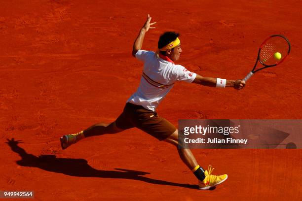 Kei Nishikori of Japan plays a backhand in his match against Rafael Nadal of Spain during day eight of ATP Masters Series: Monte Carlo Rolex Masters...