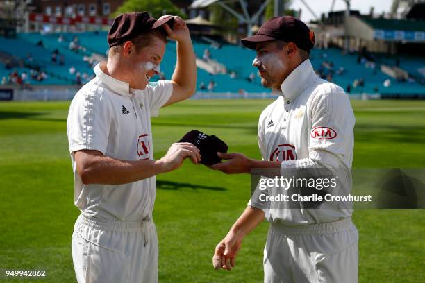 Surrey's Ollie Pope is presented with his Second XI Cap by captain Rory Burns during day three of the Specsavers County Championship Division One...