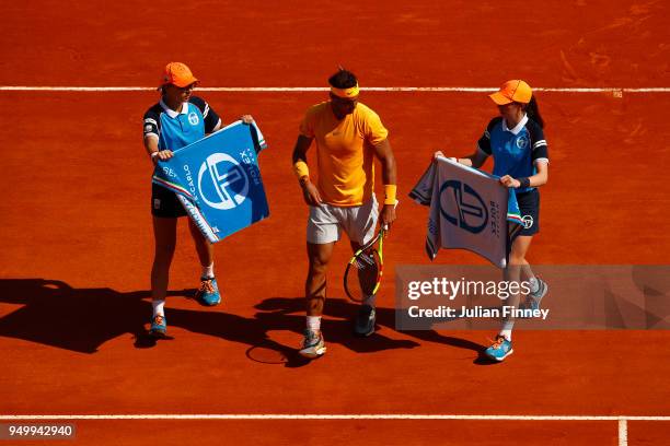 Rafael Nadal of Spain receives towels from ball kids in his match against Kei Nishikori of Japan during day eight of ATP Masters Series: Monte Carlo...