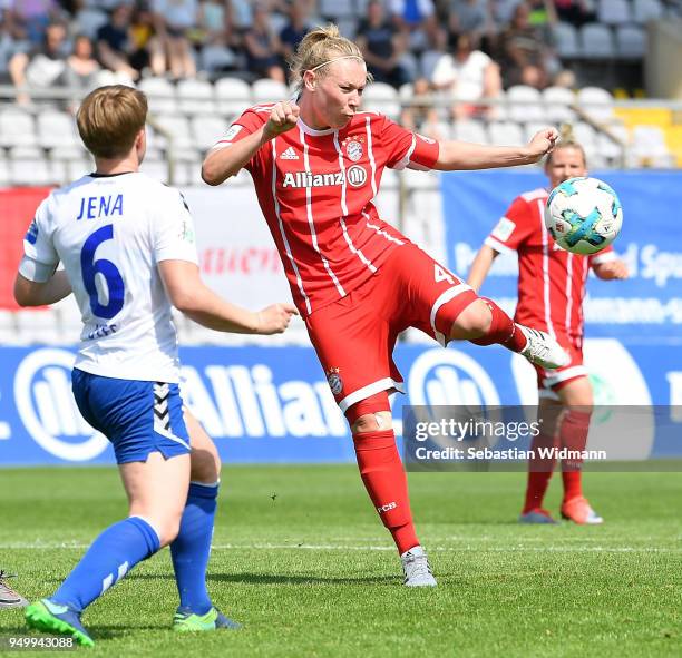 Kristin Demann of Bayern Muenchen takes a shot at the goal as Susann Utes of Jena watches during the Allianz Frauen Bundesliga match between FC...