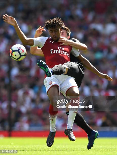 Alex Iwobi of Arsenal is tackled by Aaron Cresswell of West Ham United during the Premier League match between Arsenal and West Ham United at...