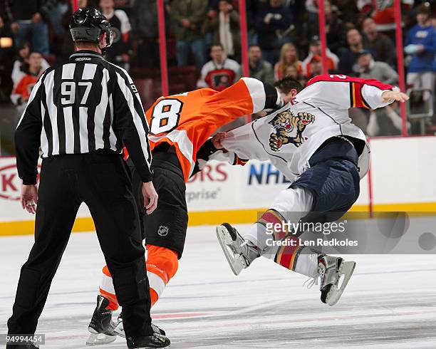 Linesman Jean Morin watches Mike Richards of the Philadelphia Flyers send Bryan McCabe of the Florida Panthers airborn on December 21, 2009 at the...