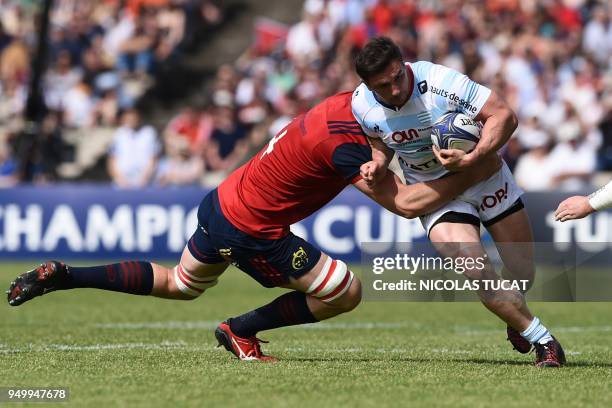 Racing 92's French centre Henry Chavancy is tackled by Munster's South African lock Jean Kleyn during the European Champions Cup semi-final rugby...