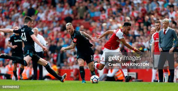 West Ham United's Austrian midfielder Marko Arnautovic fouls Arsenal's Gabonese striker Pierre-Emerick Aubameyang under the eye of Arsenal's French...