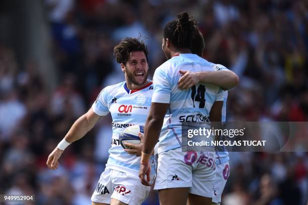 Racing 92's French scrum-half Maxime Machenaud celebrates with Racing 92's French winger Teddy Thomas after scoring a try during the European...
