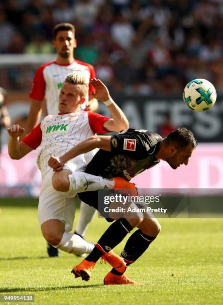 Philipp Max of Augsburg and Levin Oeztunali of Mainz battle for the ball during the Bundesliga match between FC Augsburg and 1. FSV Mainz 05 at...