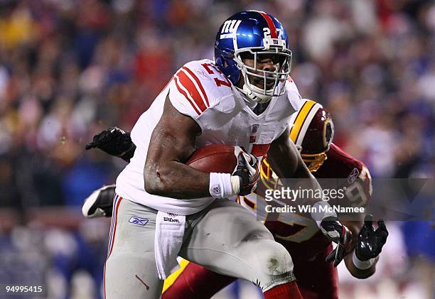 Running back Brandon Jacobs of the New York Giants rushes against the Washington Redskins at FedEx Field on December 21, 2009 in Landover, Maryland.