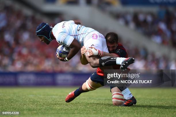 Racing 92's French prop Eddy Ben Arous is tackled by Munster's South African lock Jean Kleyn during the European Champions Cup semi-final rugby union...