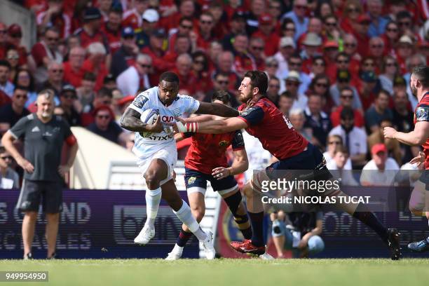 Racing 92's French winger Virimi Vakatawa runs to evade Munster's South African lock Jean Kleyn during the European Champions Cup semi-final rugby...