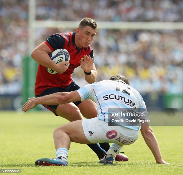 Ian Keatley of Munster is tackled by Henry Chavancy during the European Rugby Champions Cup Semi-Final match between Racing 92 and Munster Rugby at...