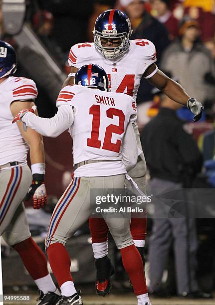 Ahmad Bradshaw of the New York Giants reacts with teammate Steve Smith after Bradshaw scored on a four-yard run in the second quarter against the...