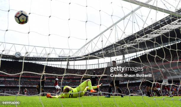 Alexandre Lacazette of Arsenal scores his side's fourth goal past Joe Hart of West Ham United during the Premier League match between Arsenal and...