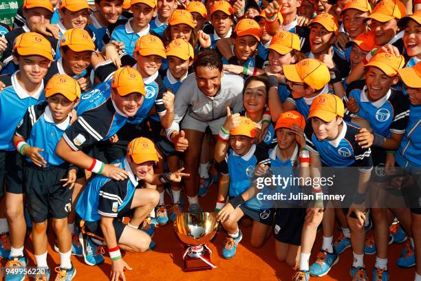 Rafael Nadal of Spain poses his winners trophy and the ball kids after winning the Monte Carlo Rolex Masters against Kei Nishikori of Japan during...